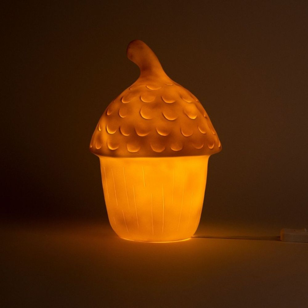 Glowing acorn-shaped lamp on a dark background